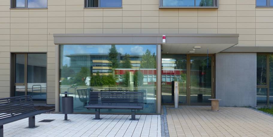 Der Haupteingang des Büro- und Verwaltungsgebäudes - im Spiegelbild das gegenüberliegende alte Rechenzentrum mit roter Fassade, welches nach Inbetriebnahme des neuen RZ abgebrochen wird. © 2020 SBL Greifswald