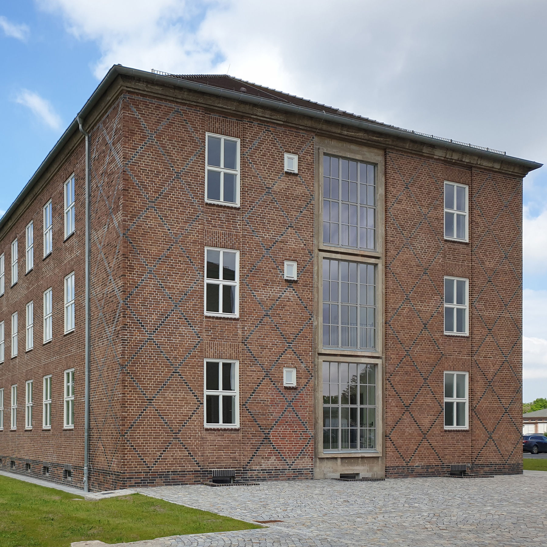Giebel Gebäude 2 - Als sparsamer Fassadenschmuck wurden an den Gebäudeenden und Giebeln rautenförmige Ornamente aus dunklen Klinkern in die Flächen integriert. © 2021 SBL Neubrandenburg
