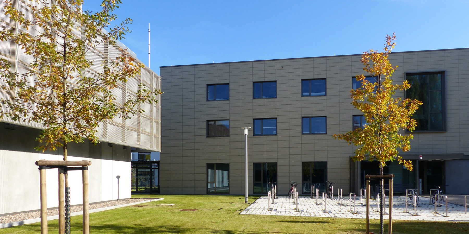 Durch die rechtwinklige Anordnung von Rechnergebäude und Seminar- und Verwaltungsgebäude entsteht eine einladende Vorplatzsituation im Eingangsbereich © 2021 SBL Greifswald