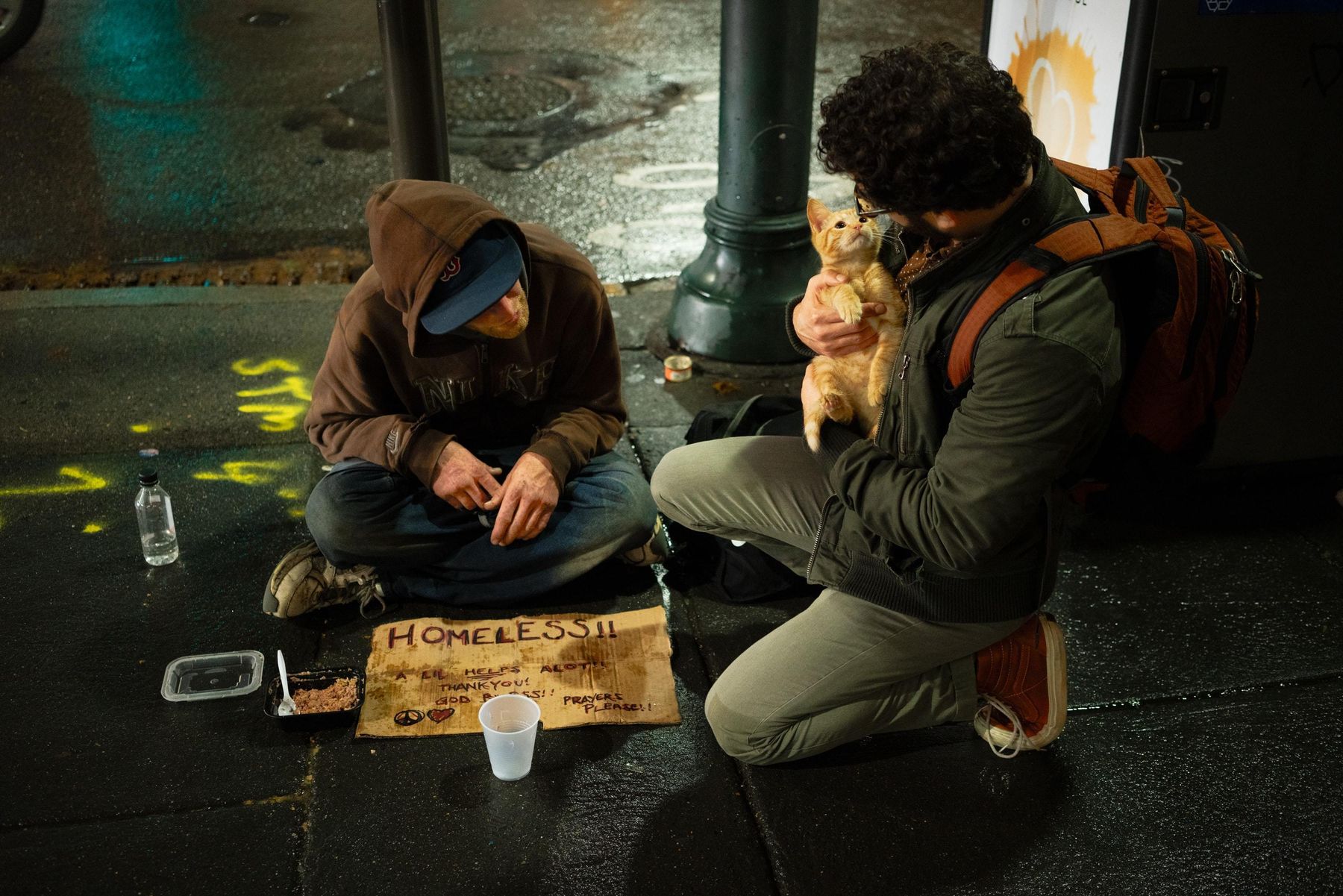 Obdachloser Mann spricht mit Passanten